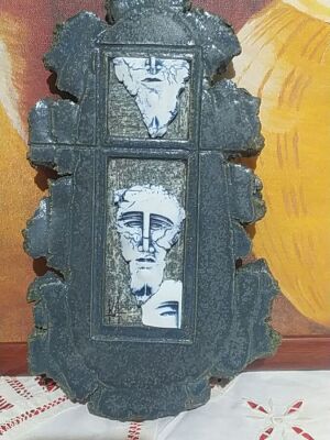 Handmade stone wall decoration with embossed ancient-style faces